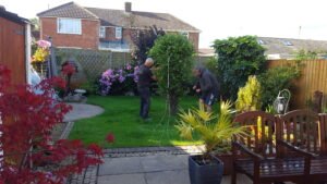 Steve and Phil sorting clothes line out b4 artificial grass job in Heswall - Artificial Grass Wirral Steve and Phil checking clothes lines positioning before the work starts at artificial grass job in Heswall.